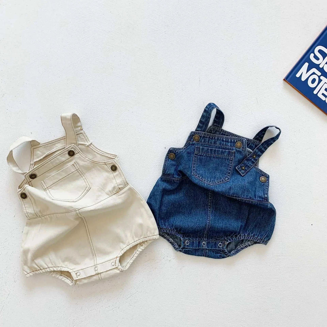 Denim Baby OverallsIndulge in undeniable cuteness with our denim overalls and matching t-shirts, thoughtfully crafted from 95% cotton. These versatile pieces are an absolute must-have KORSH KORSH Denim Baby Overalls